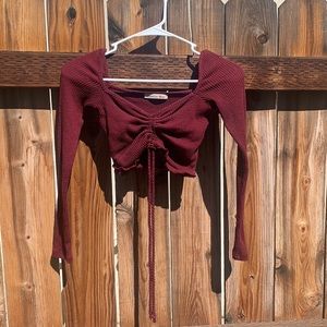 Cute burgundy long sleeve crop top with adjustable strings in the front